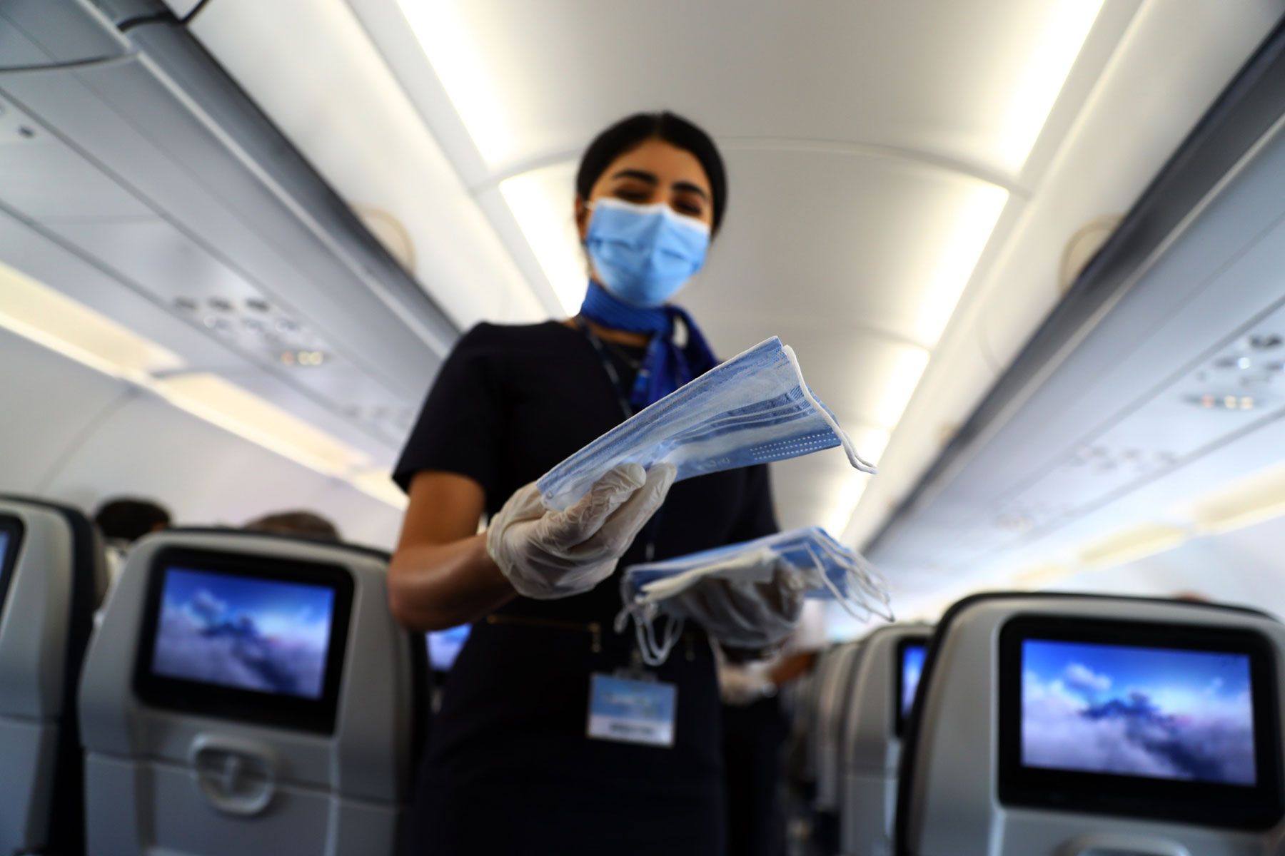 Flugbegleiter-Gesichtsmasken für Passagiere in einem Flugzeug